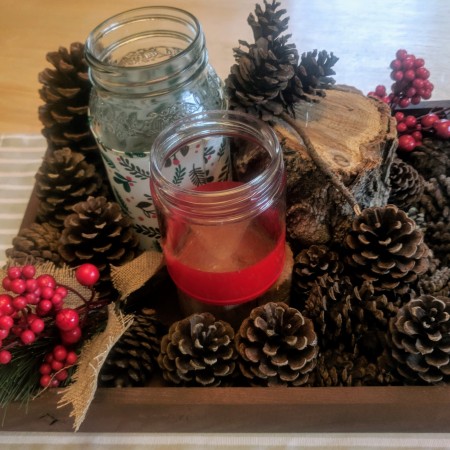 brown box 1.5" tall with pine cones, artificial red berries and decorative jars