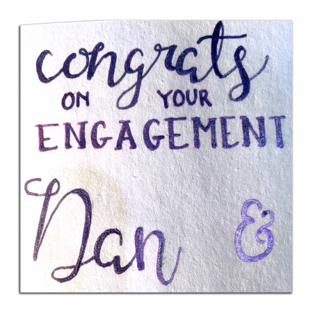 hand lettered card reading "Congrats on your Engagement Dan & Noomi"